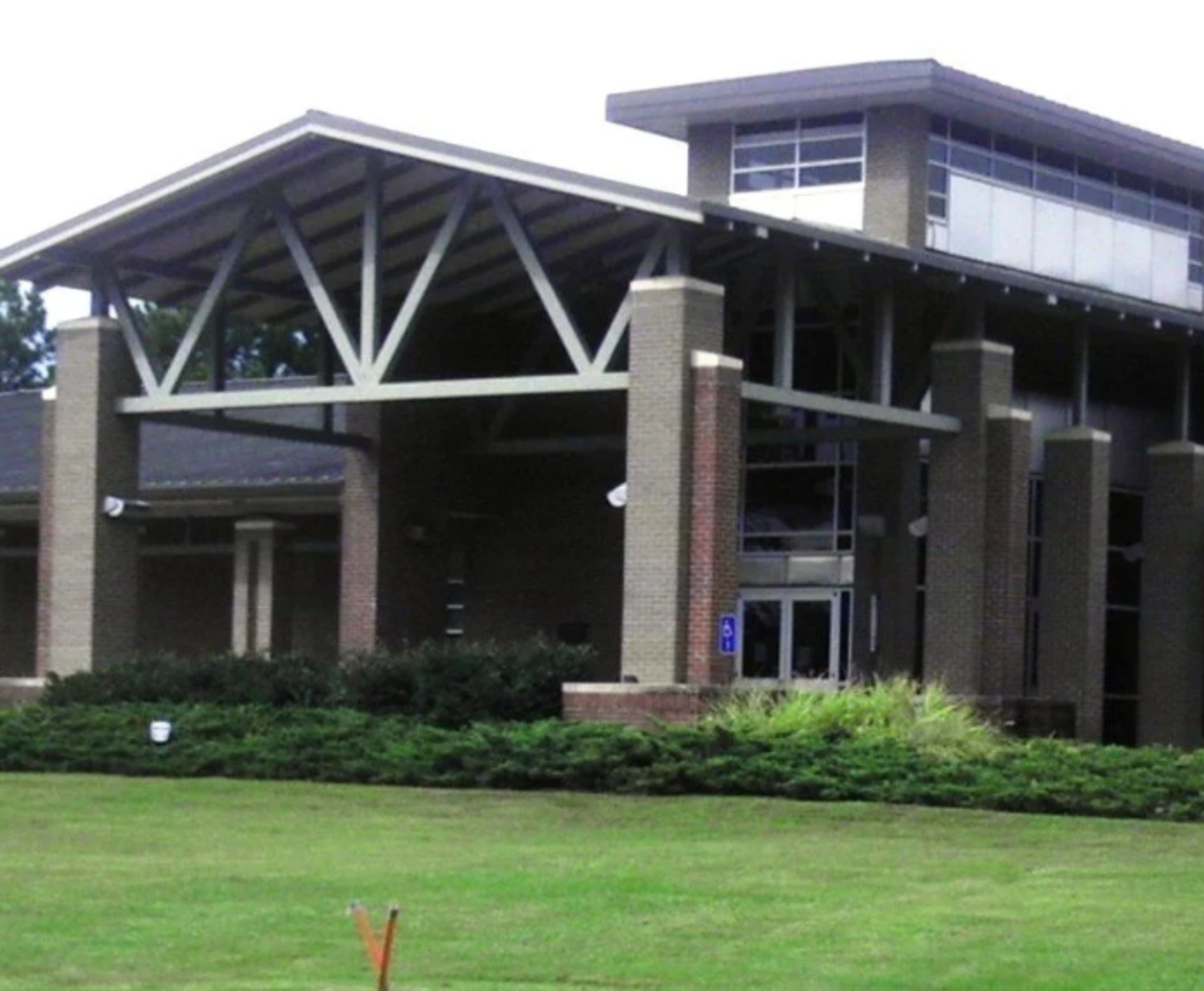 G. Chastaine Flynt Memorial Library with brick exterior, glass entrance, and landscaped lawn.