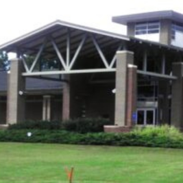G. Chastaine Flynt Memorial Library with brick exterior, glass entrance, and landscaped lawn.