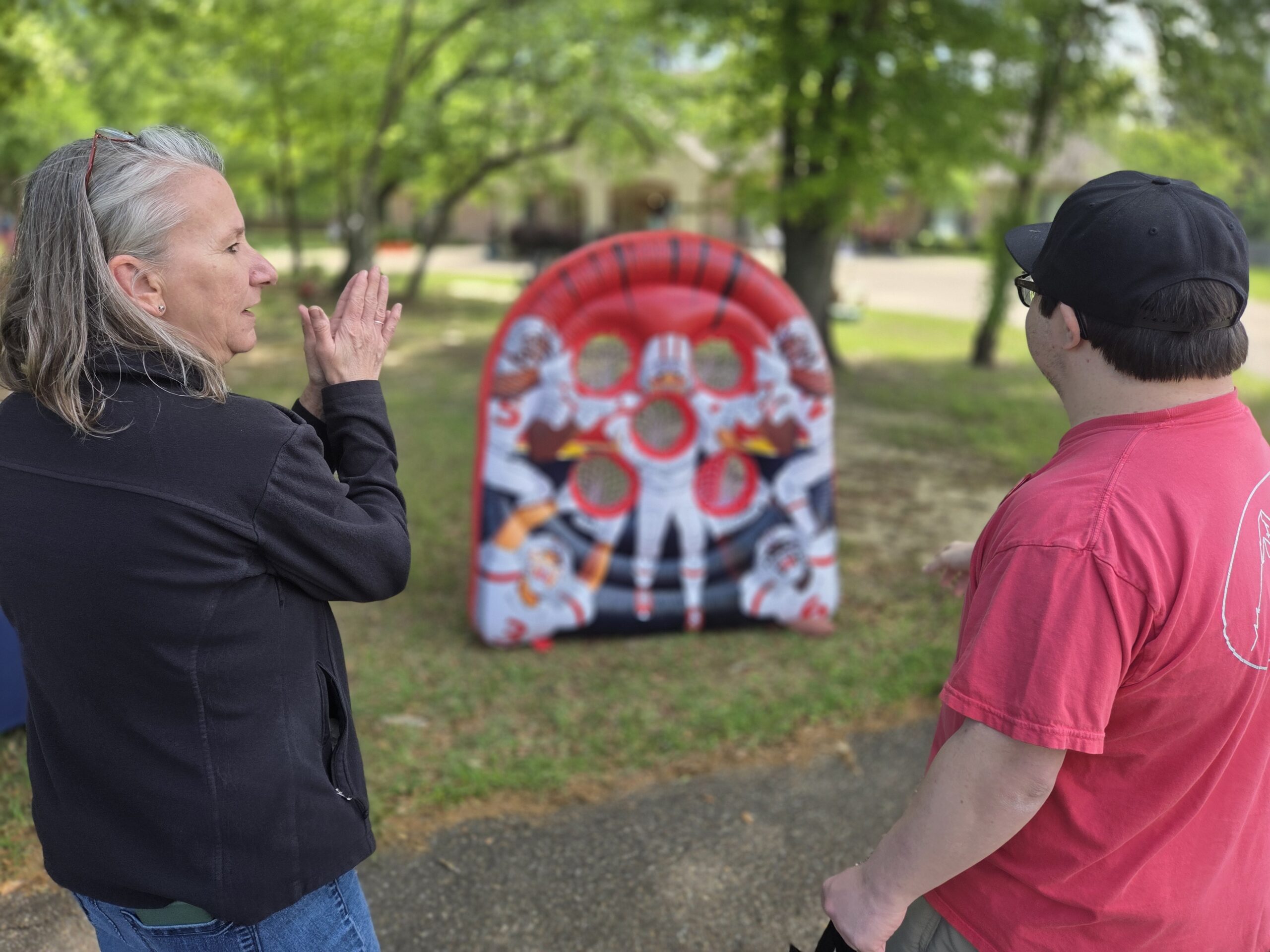 Two people talking and playing a football game.